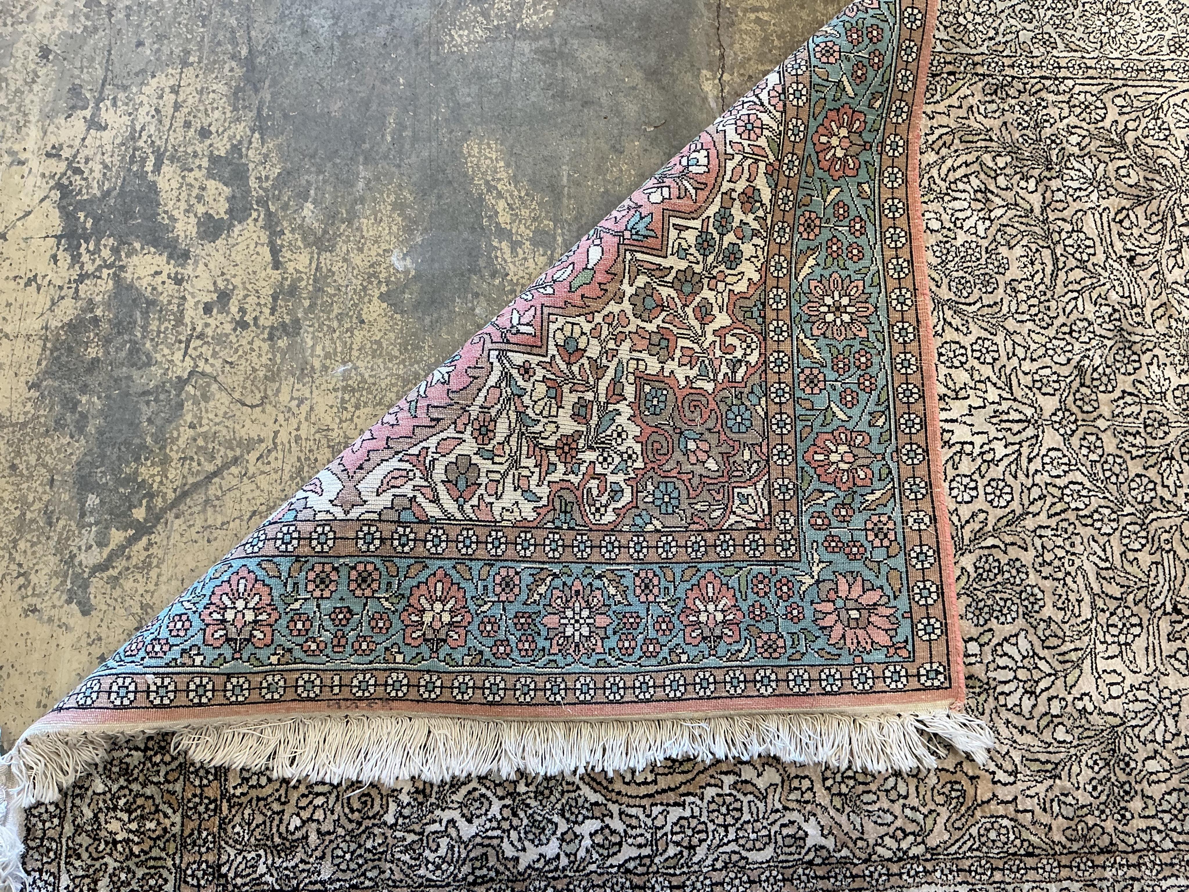 A North West Persian faded red ground rug, 191 x 120cm